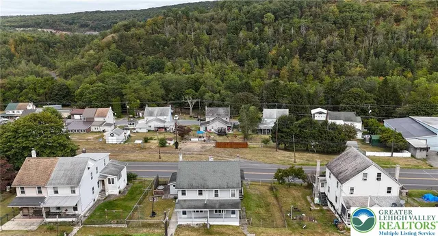 an aerial view of residential houses with outdoor space