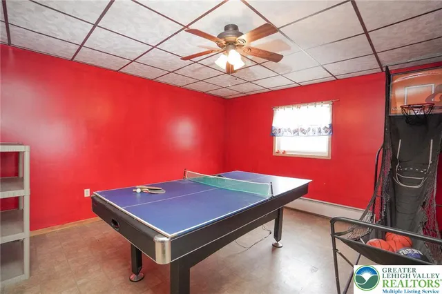 a room with pool table windows and wooden floor