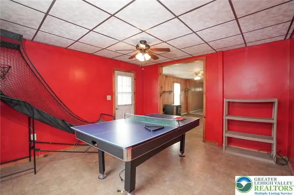 a room with pool table and window