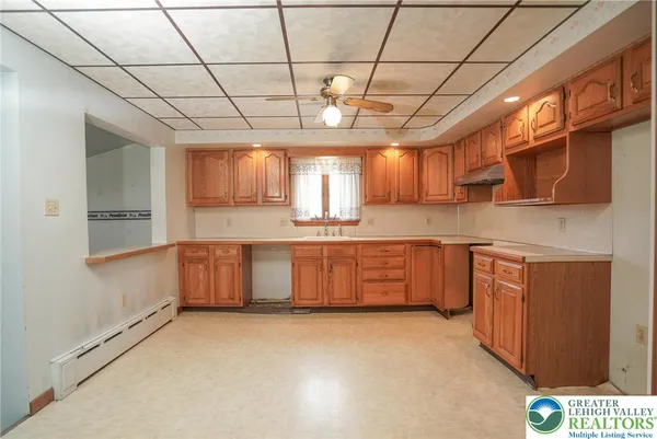 a large kitchen with a large window cabinets and stainless steel appliances