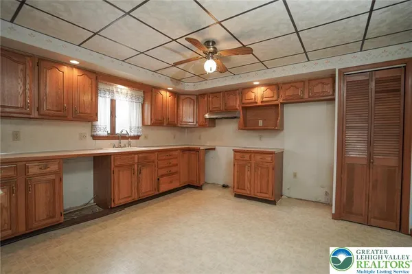 a kitchen with cabinets a window and appliances