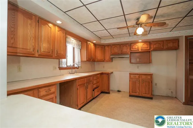 a kitchen with stainless steel appliances granite countertop a sink a stove cabinets and wooden floor