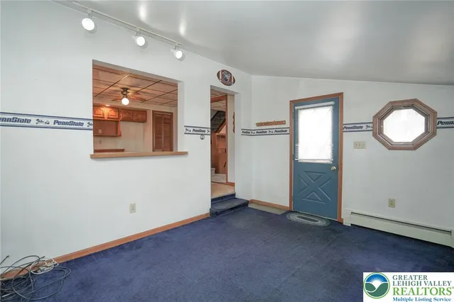 an empty room with window and mirror