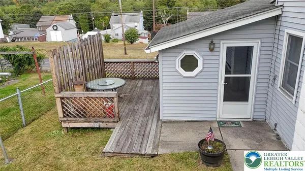 a view of a chairs and table in backyard