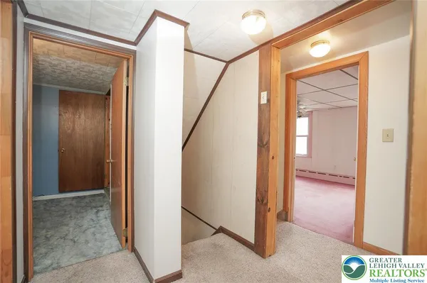 a view of a hallway with wooden floor and entryway