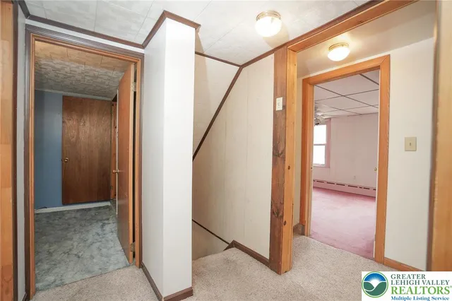 a view of a hallway with wooden floor and entryway