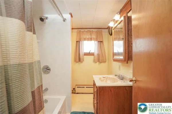 a bathroom with a sink a bath tub and a shower