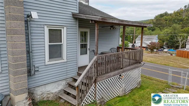a view of porch with deck and outdoor seating