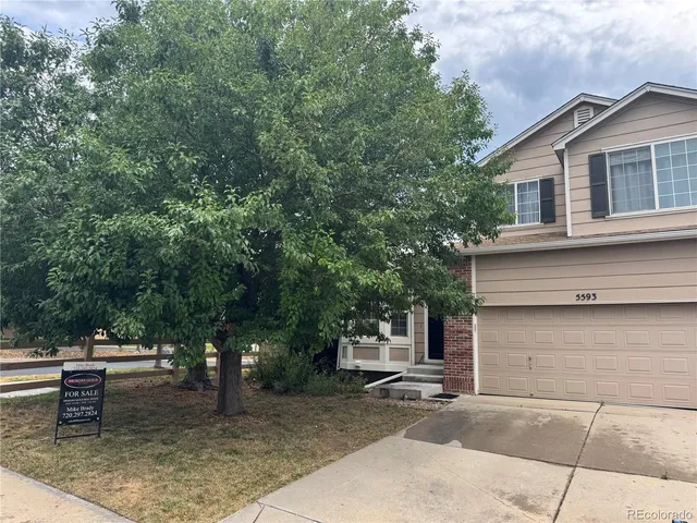 a backyard of a house with outdoor seating