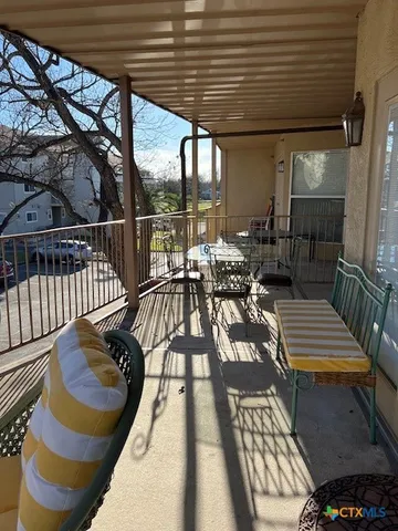 a view of balcony with wooden floor