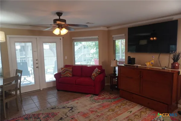 a living room with furniture and a flat screen tv