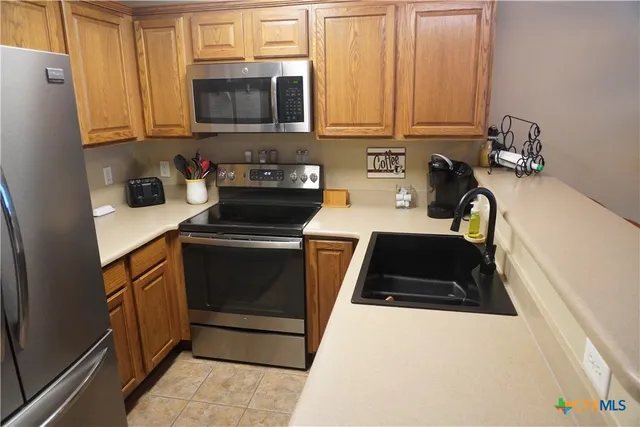 a kitchen with a sink and a stove top oven