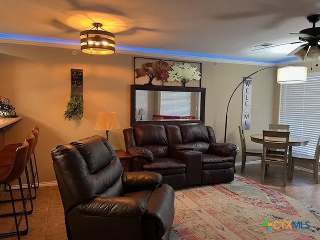 a living room with furniture and a mirror