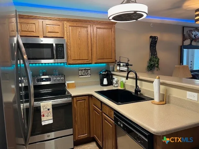 a kitchen with a sink a stove and cabinets