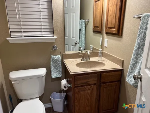 a bathroom with a toilet sink and mirror