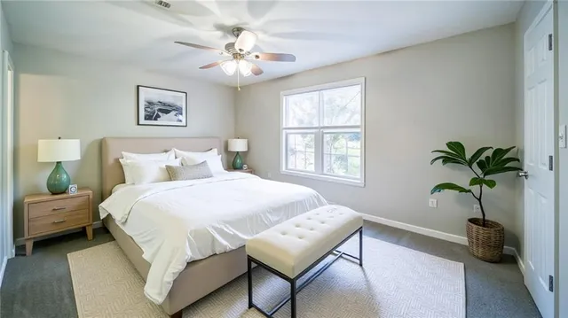 a bedroom with a large bed and a window