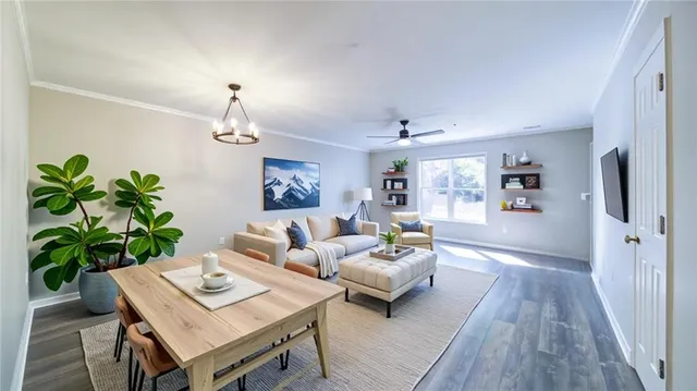 a living room with furniture a chandelier and a wooden floor
