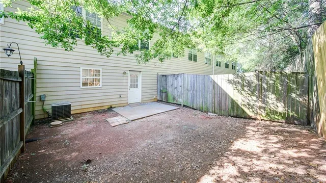 a view of a backyard with a tree