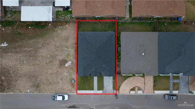 an aerial view of a house with a yard