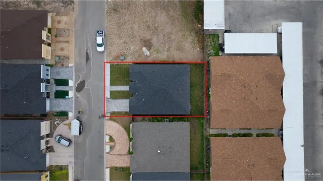 an aerial view of residential houses with outdoor space