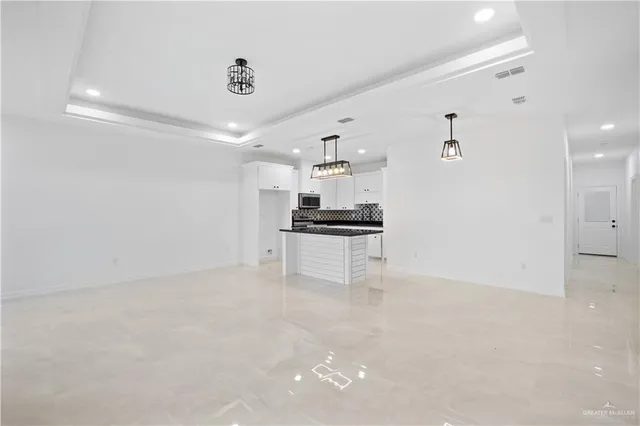 a view of kitchen with refrigerator and cabinets
