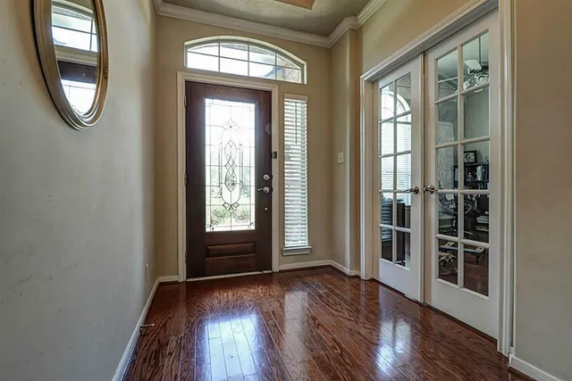 wooden floor in an empty room with a window