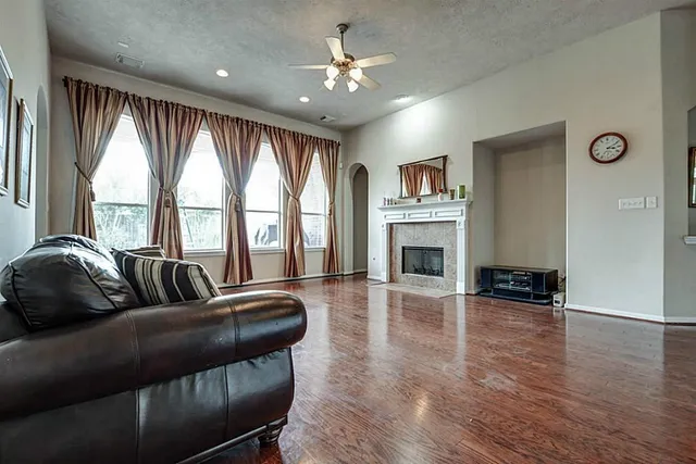 a living room with furniture fireplace and flat screen tv