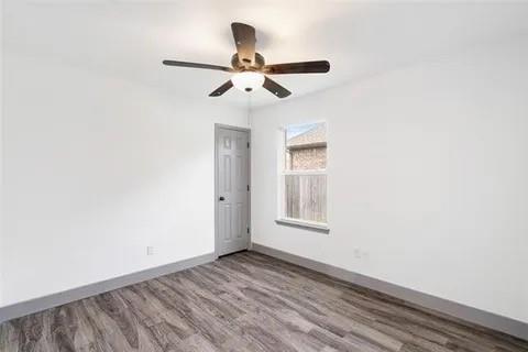 1404 Swan Ridge Drive Sherman, TX 75092 - Photo 12 of 16 a view of empty room with wooden floor and fan