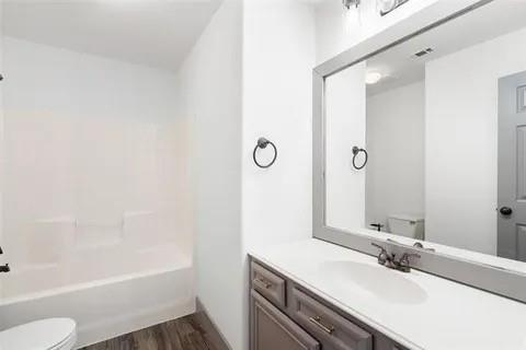1404 Swan Ridge Drive Sherman, TX 75092 - Photo 14 of 16 a bathroom with a sink and a mirror