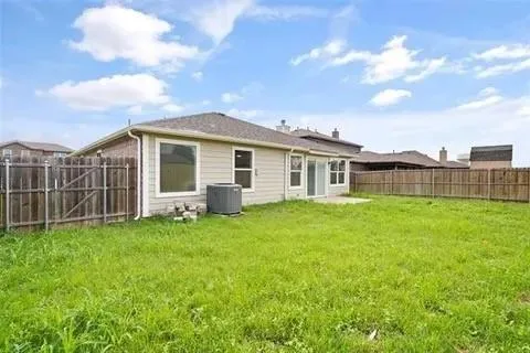 a view of a house with backyard and porch