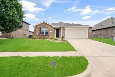 a front view of a house with a garden and yard