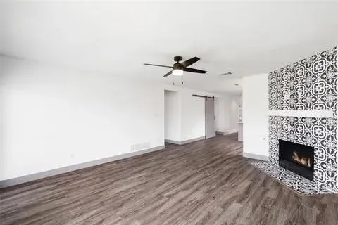 a view of a room with wooden floor and a fireplace