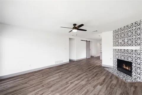 1404 Swan Ridge Drive Sherman, TX 75092 - Photo 5 of 16 a view of a room with wooden floor and a fireplace