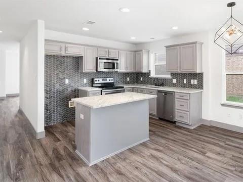 1404 Swan Ridge Drive Sherman, TX 75092 - Photo 8 of 16 a kitchen with a sink stove and cabinets