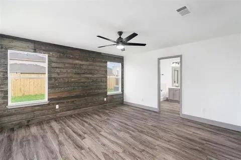 wooden floor in an empty room with a window