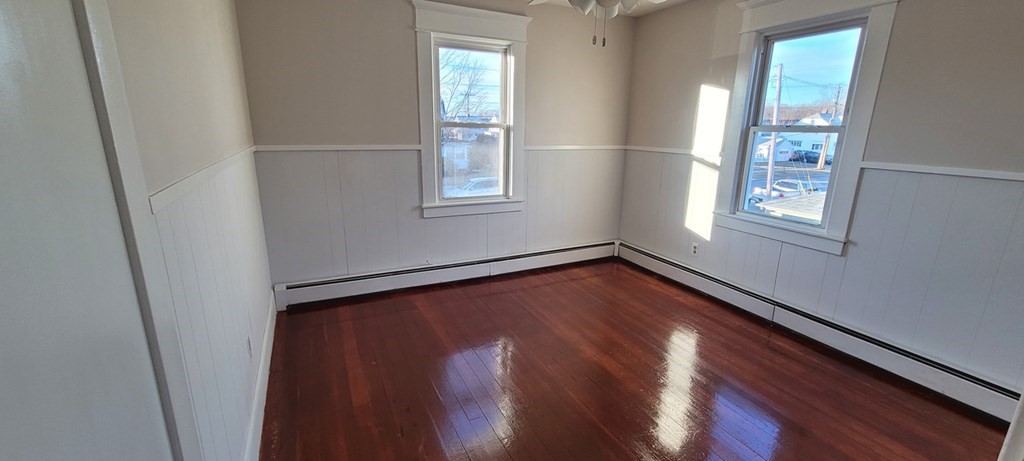 91 Rimmon Avenue Chicopee, MA 01013 - Photo 11 of 18 a view of an empty room with wooden floor and a window