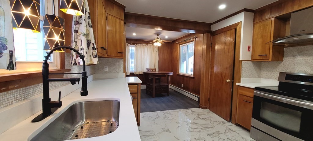 91 Rimmon Avenue Chicopee, MA 01013 - Photo 2 of 18 a kitchen with stainless steel appliances granite countertop a sink a stove and a refrigerator