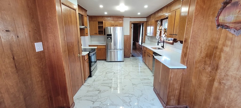 91 Rimmon Avenue Chicopee, MA 01013 - Photo 5 of 18 a kitchen with stainless steel appliances a refrigerator and a sink