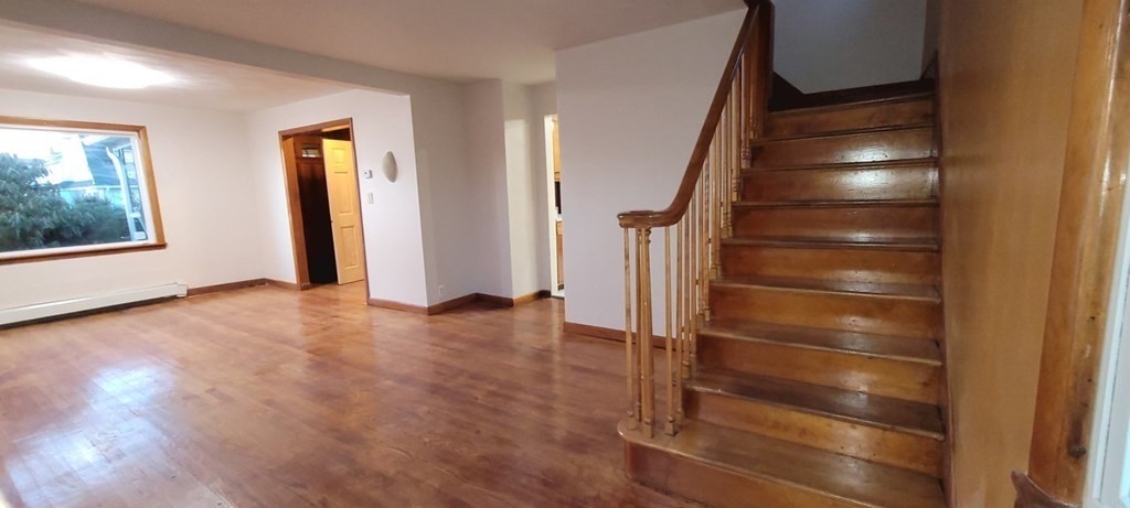 91 Rimmon Avenue Chicopee, MA 01013 - Photo 8 of 18 a view of an empty room with wooden floor and windows