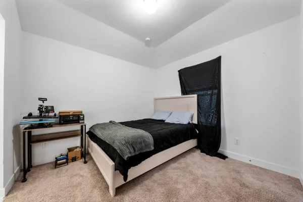 a bedroom with a bed and a television