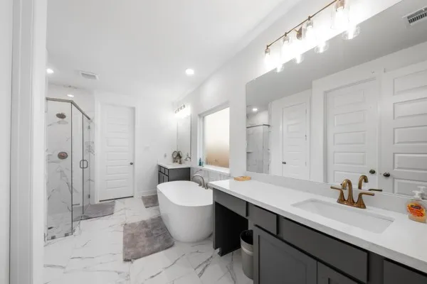 a large bathroom with a double vanity sink mirror and double