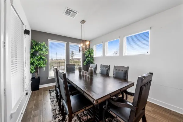 a view of a dining room with furniture window and wooden floor