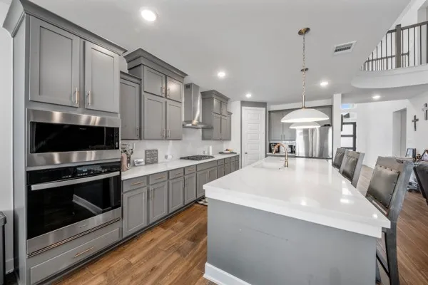 a kitchen with stainless steel appliances kitchen island granite countertop a sink and cabinets