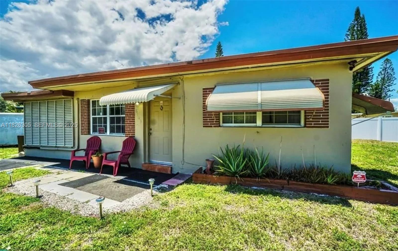 a view of a house with backyard sitting area and garden