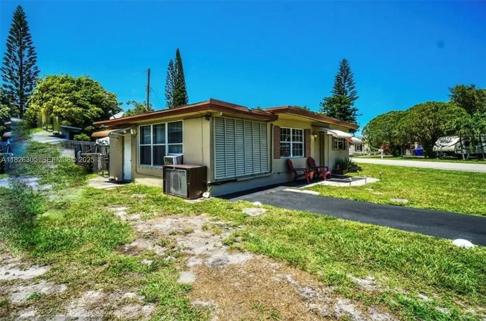 6103 Monroe Street Hollywood, FL 33023 - Photo 3 of 9 a view of a house with yard and a garden