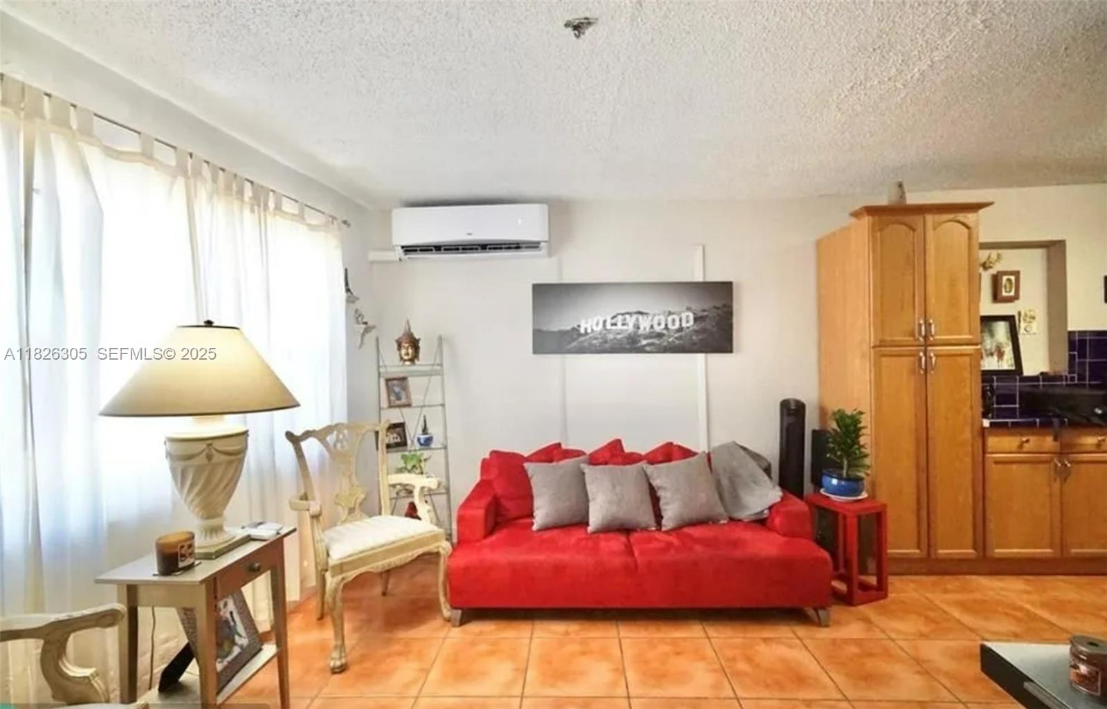 6103 Monroe Street Hollywood, FL 33023 - Photo 6 of 9 a bedroom with a bed and wooden floor