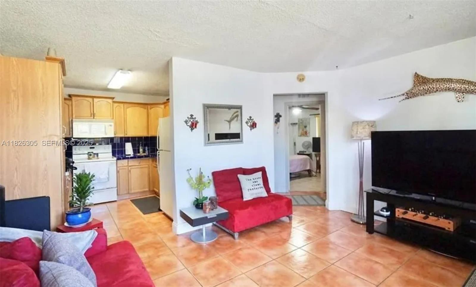6103 Monroe Street Hollywood, FL 33023 - Photo 8 of 9 a living room with furniture and a flat screen tv