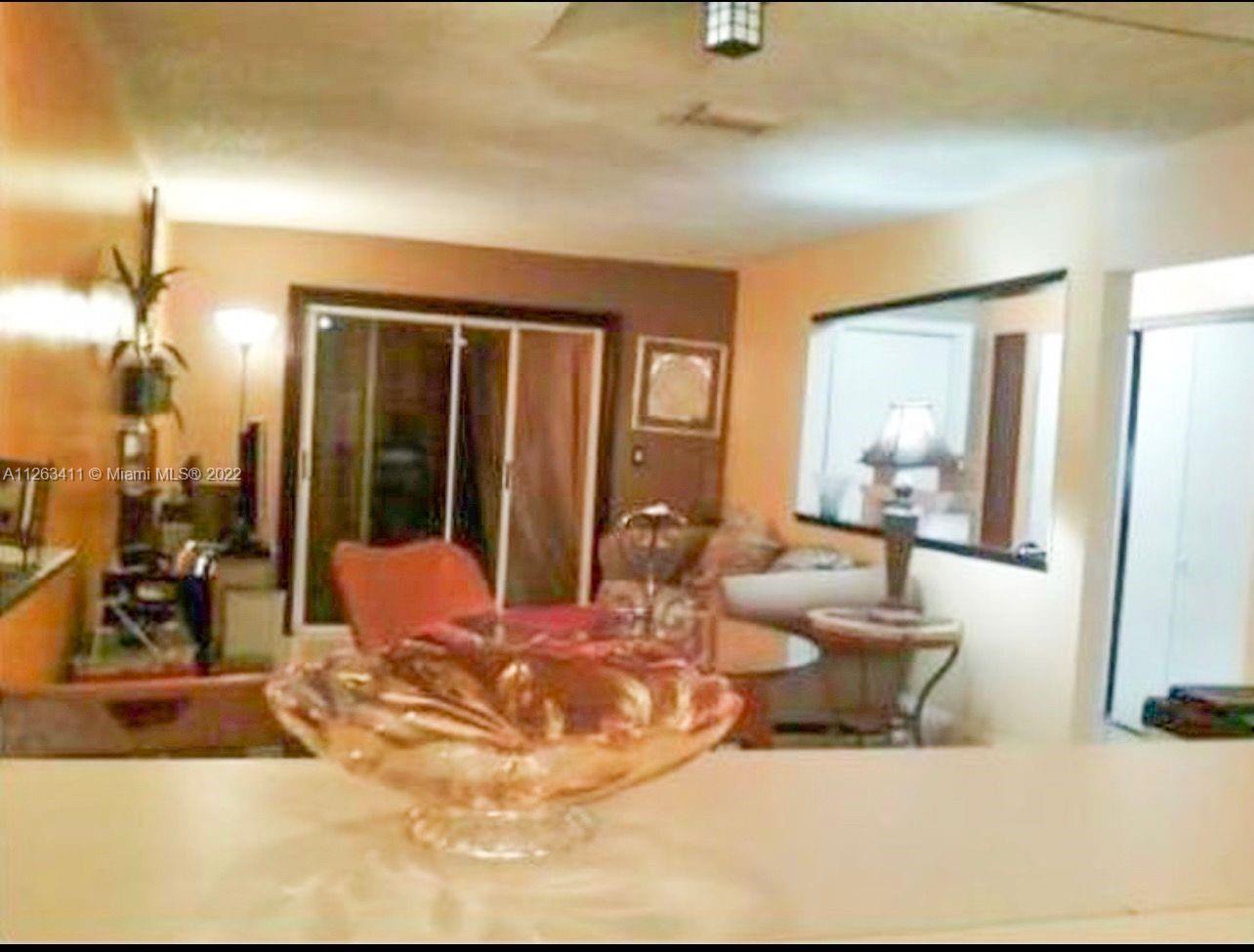 422 Northwest 8th Street Miami, FL 33136 - Photo 2 of 4 a living room with furniture and large mirror