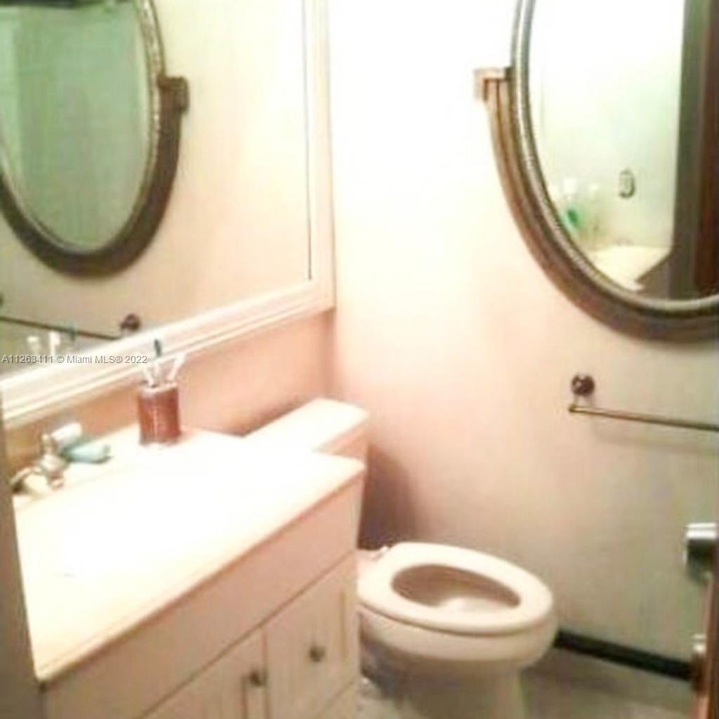 422 Northwest 8th Street Miami, FL 33136 - Photo 4 of 4 a bathroom with a sink and a mirror