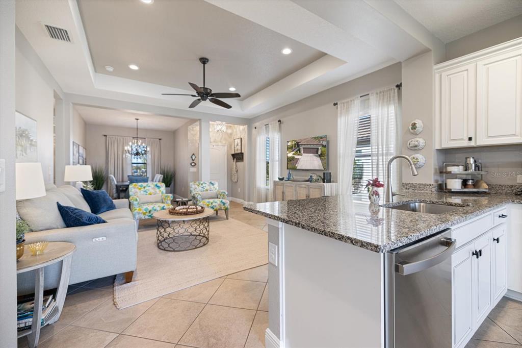 208 Brienza Loop Nokomis, FL 34275 - Photo 11 of 45 a living room with furniture a chandelier and kitchen view